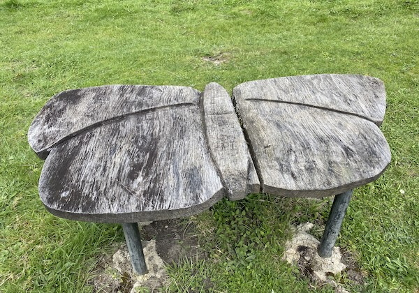 A wooden seat in the shape of a butterfly