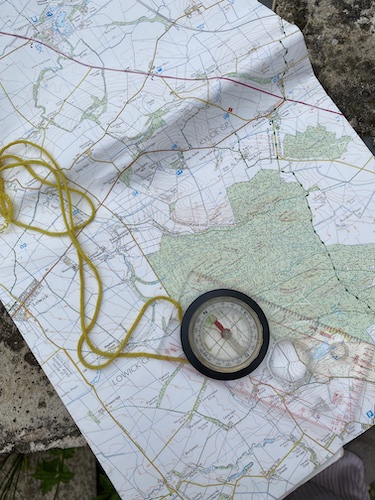 Compass laying on an ordinance survey map