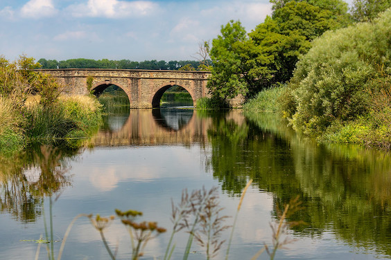 Bridge crossing the River Nene at Oundle on a calm day